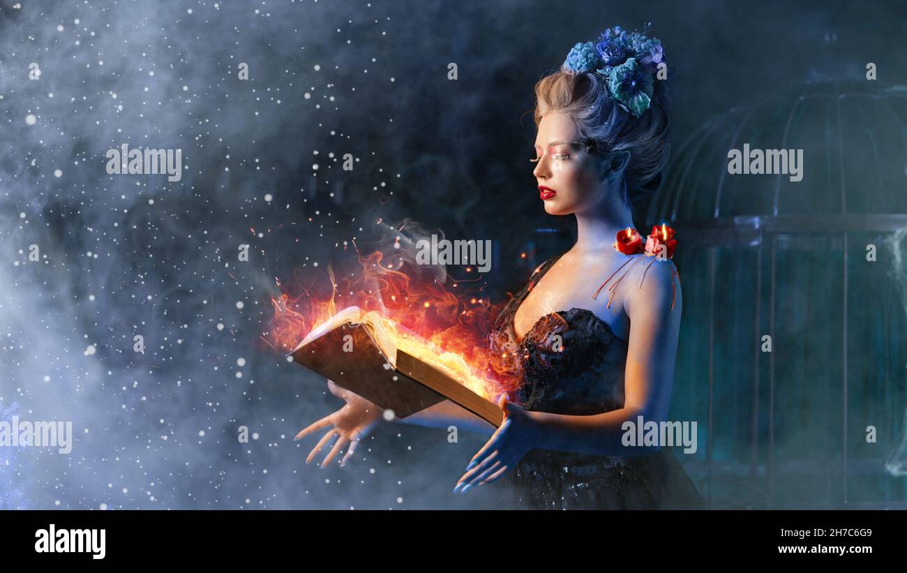 Concept de conte de fées de Noël.Reine des neiges appelant l'hiver utiliser livre de sort avec incantation de feu.Enchantement femelle utilisation du feu magie combat avec froid gagner Banque D'Images