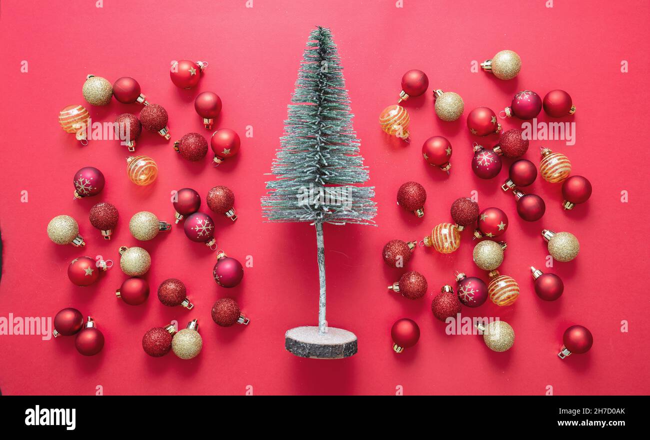 Sapin de Noël et boules de décoration sur fond rouge.Boules de Noël rouge et or.Joyeux Noël nouvel an, vue du dessus Banque D'Images