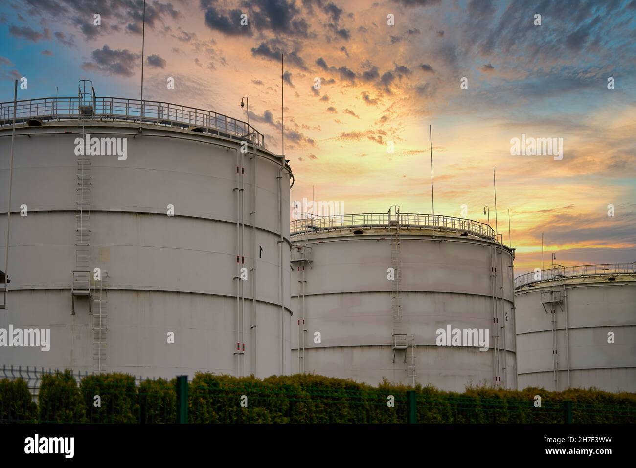 Réservoir d'huile de stockage en vrac, ciel de coucher de soleil à angle bas. Banque D'Images