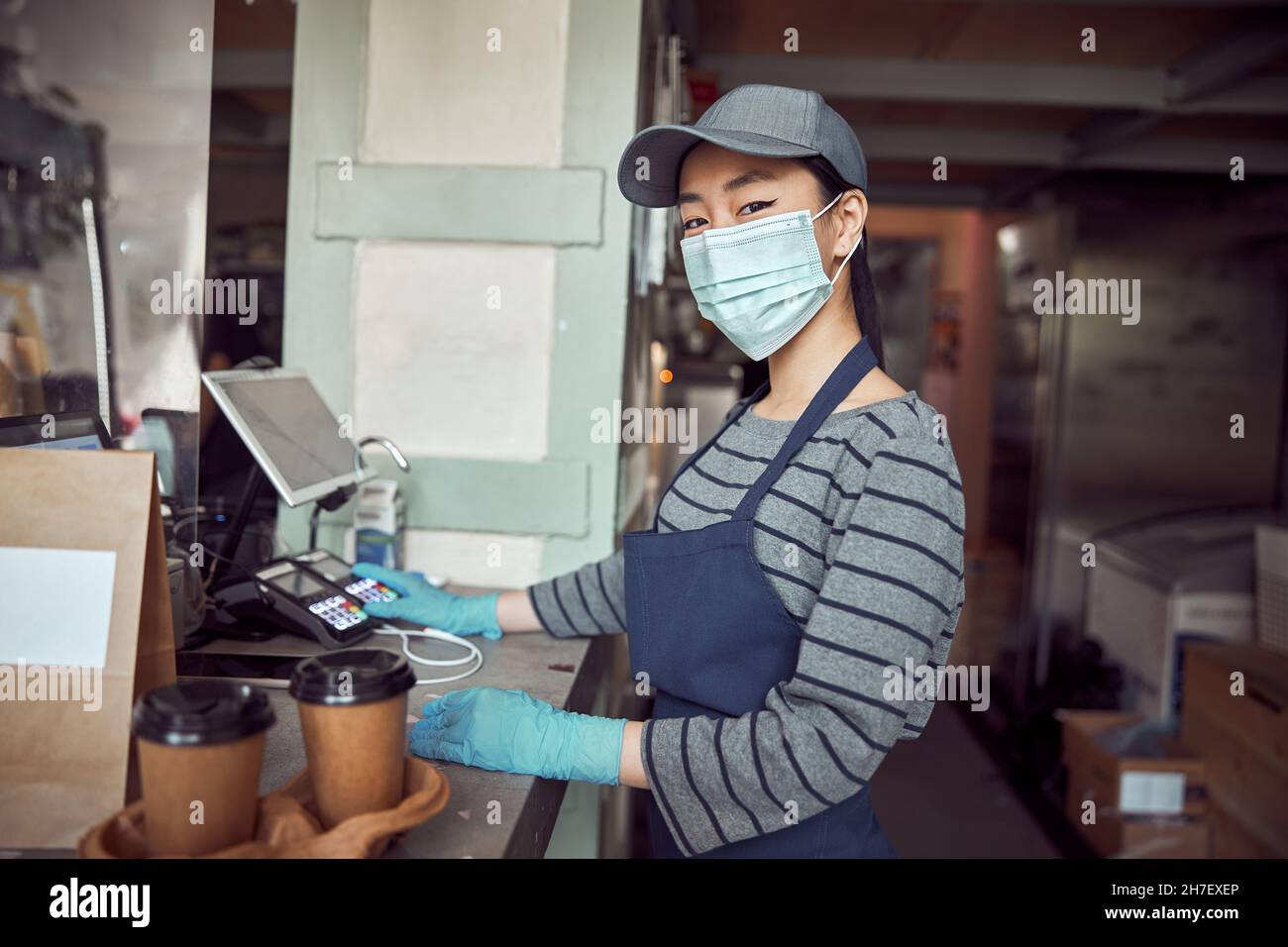 Jeune femme travaillant avec un repas à emporter dans le restaurant Banque D'Images