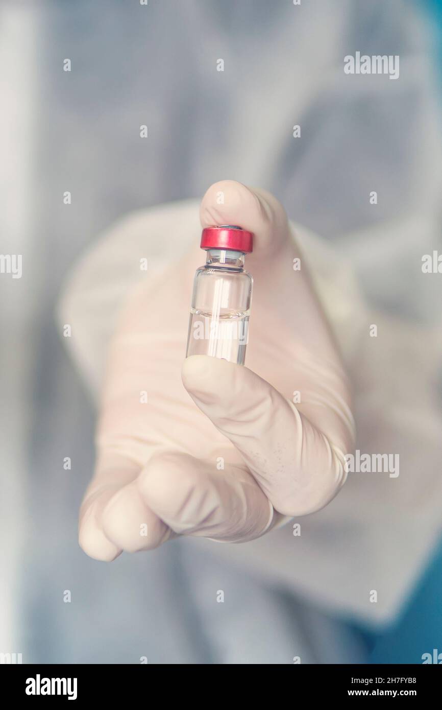 covid 19 corona virus ampoule vaccin cure dans le médecin scientifique main . photo verticale Banque D'Images