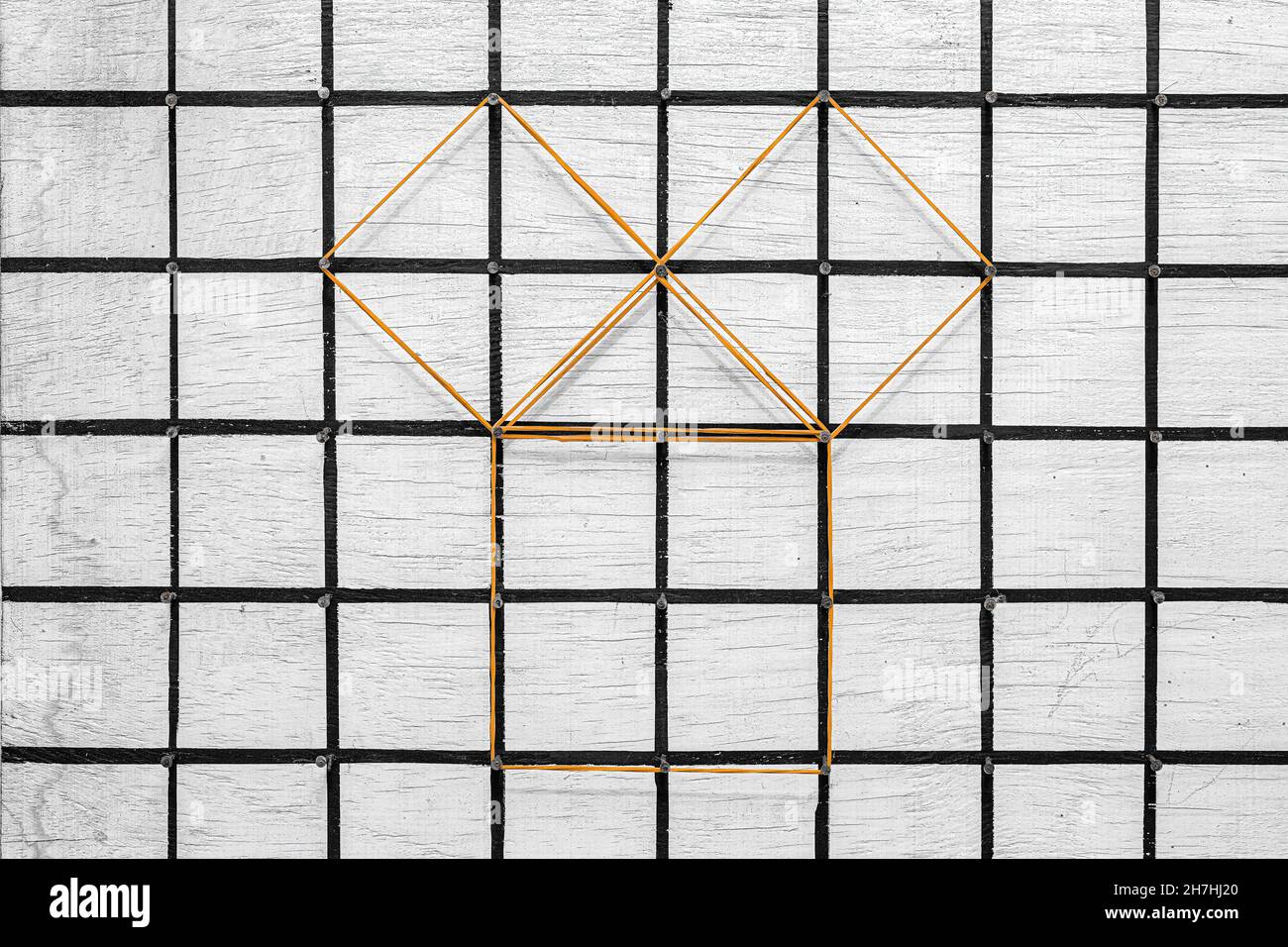 Geoplane blanc en bois et clous grilles noires peintes avec des bandes de caoutchouc de bureau représentant le théorème pythagore Banque D'Images