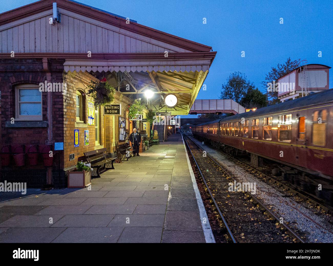 Dernier train partant de la gare de Toddington au crépuscule, GWR Steam Railway Banque D'Images