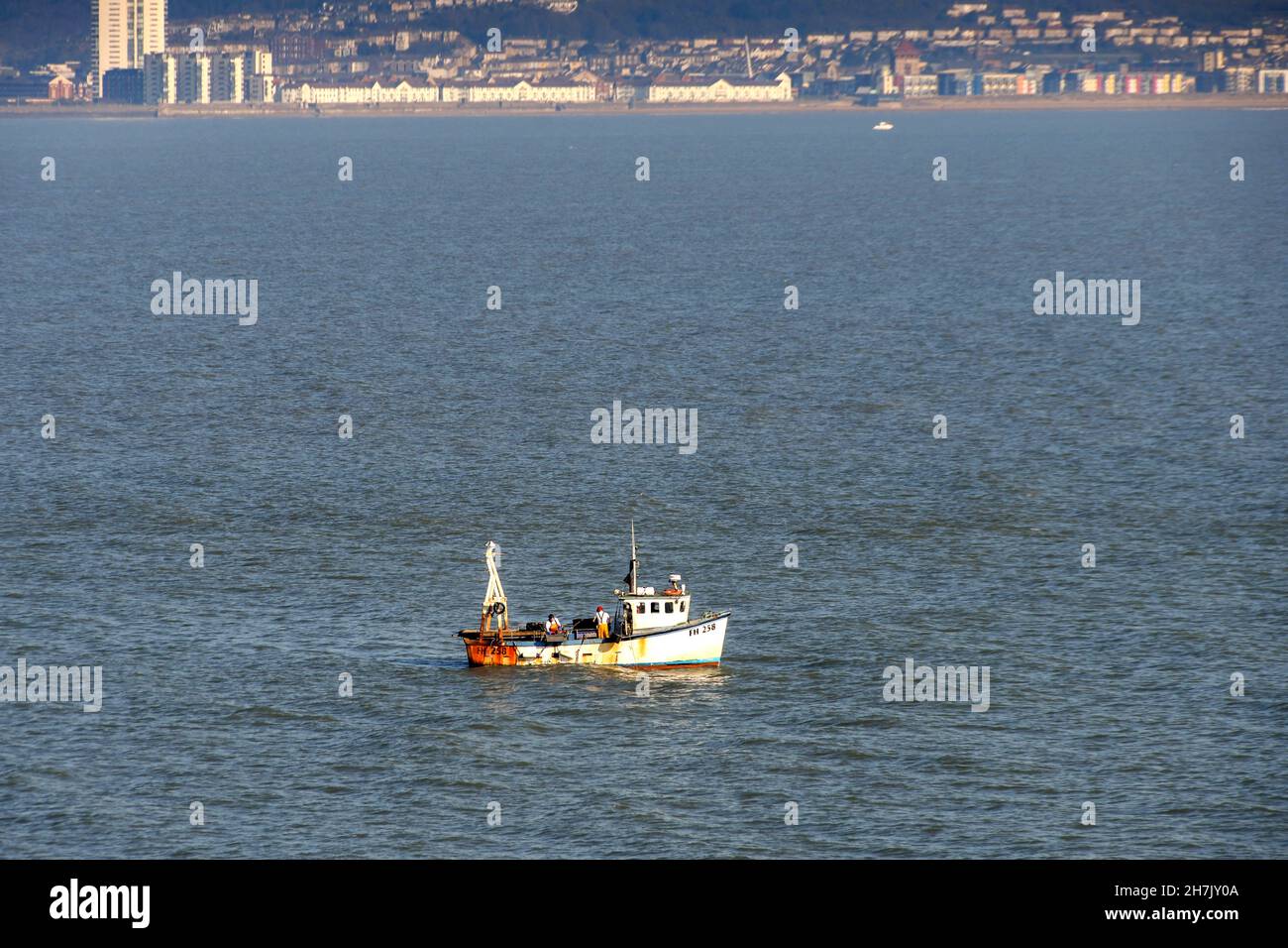 Mumbles, Swansea, pays de Galles - février 2019 : pêcheurs travaillant sur un petit bateau dans la baie de Swasea. Banque D'Images