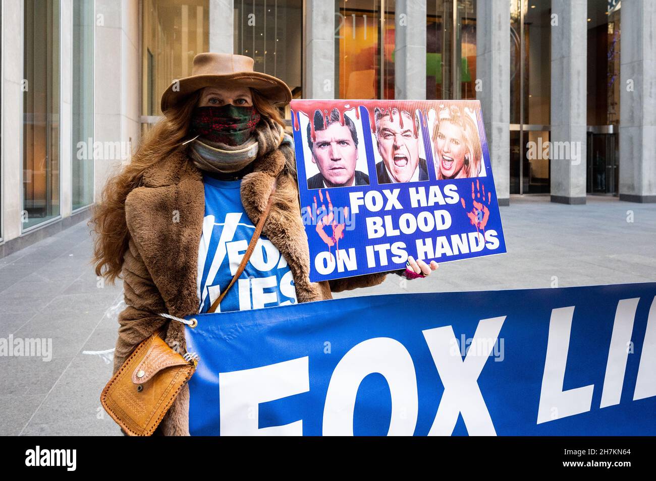 New York, États-Unis.23 novembre 2021.Une femme tient un panneau indiquant « Fox a du sang sur ses mains » lors d'une manifestation contre Fox News devant son bâtiment sur la Sixième Avenue.Crédit : SOPA Images Limited/Alamy Live News Banque D'Images