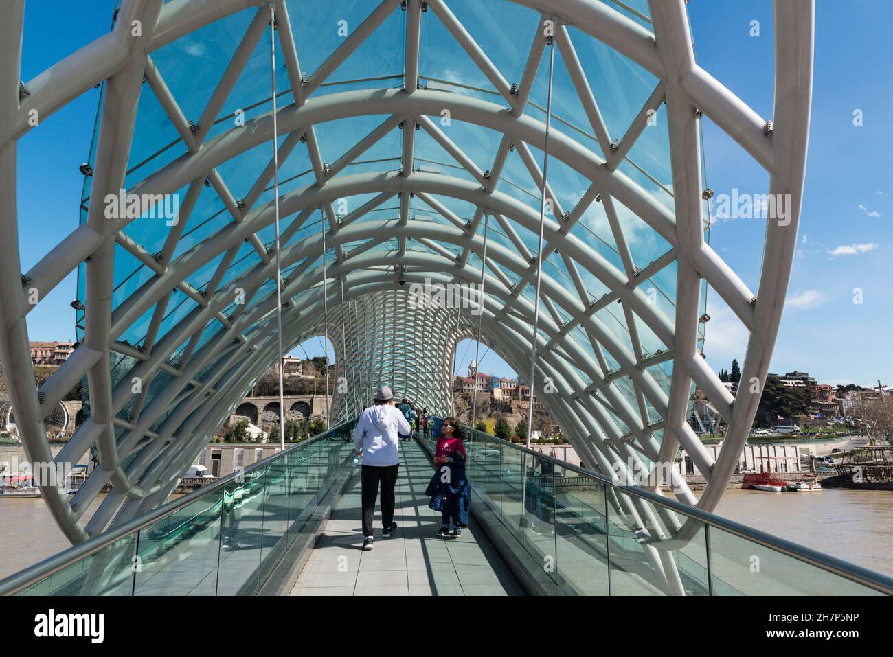 Piétons sur le pont emblématique de la paix au-dessus de la rivière Kura à Tbilissi, Géorgie, Caucase Banque D'Images