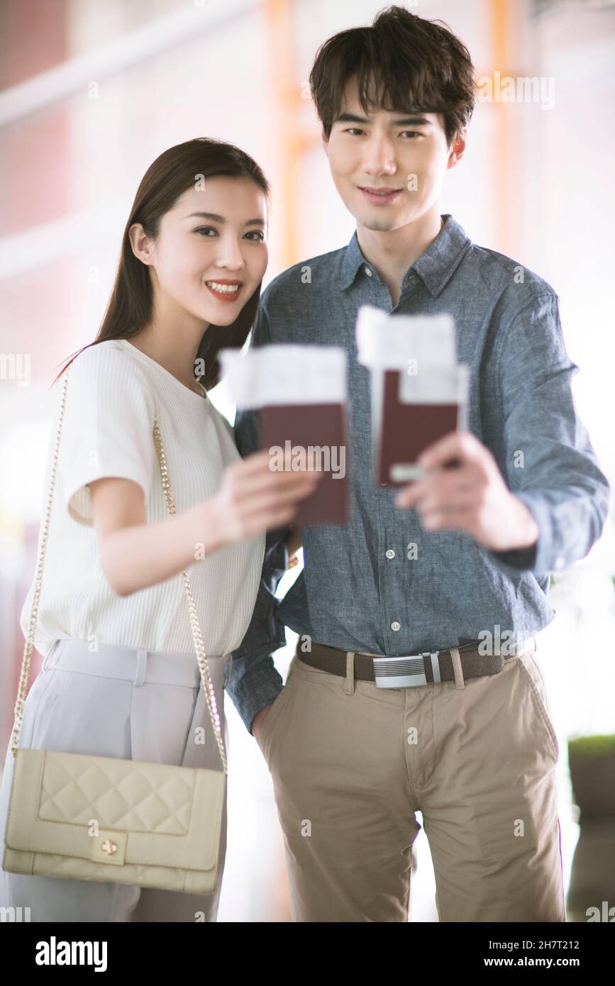 Jeune couple tenant des billets et des passeports Banque D'Images