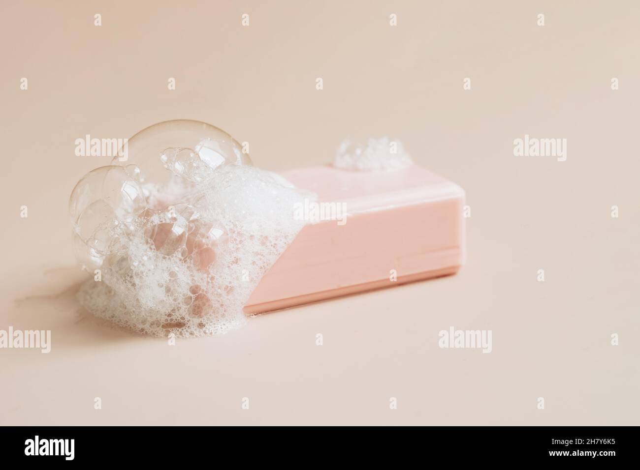 Savon naturel bio fait à la main avec de grandes bulles de mousse sur fond pastel.Santé beauté produits naturels concept. Banque D'Images