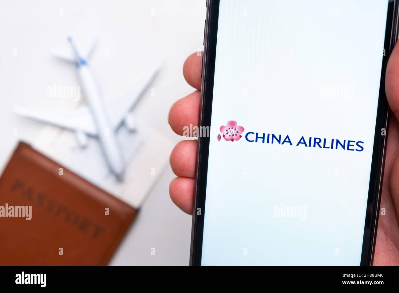 Logo de l'application China Airlines sur l'écran du téléphone portable.Image floue d'un avion, d'un passeport et d'une carte d'embarquement en arrière-plan.Novembre 2021, San Francisco, États-Unis Banque D'Images