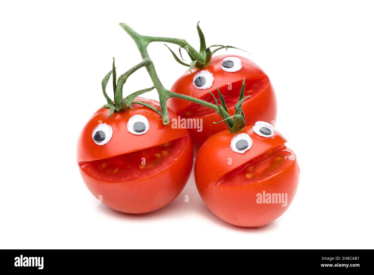Trois tomates rires isolées sur fond blanc Banque D'Images