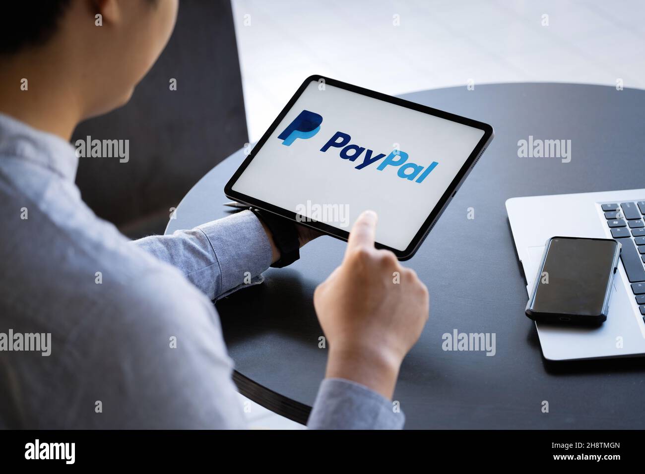 CHIANG MAI, THAÏLANDE - 28 NOVEMBRE 2021 : homme mains tenant ipad avec des applications PayPal sur l'écran.PayPal est un système de paiement électronique en ligne. Banque D'Images