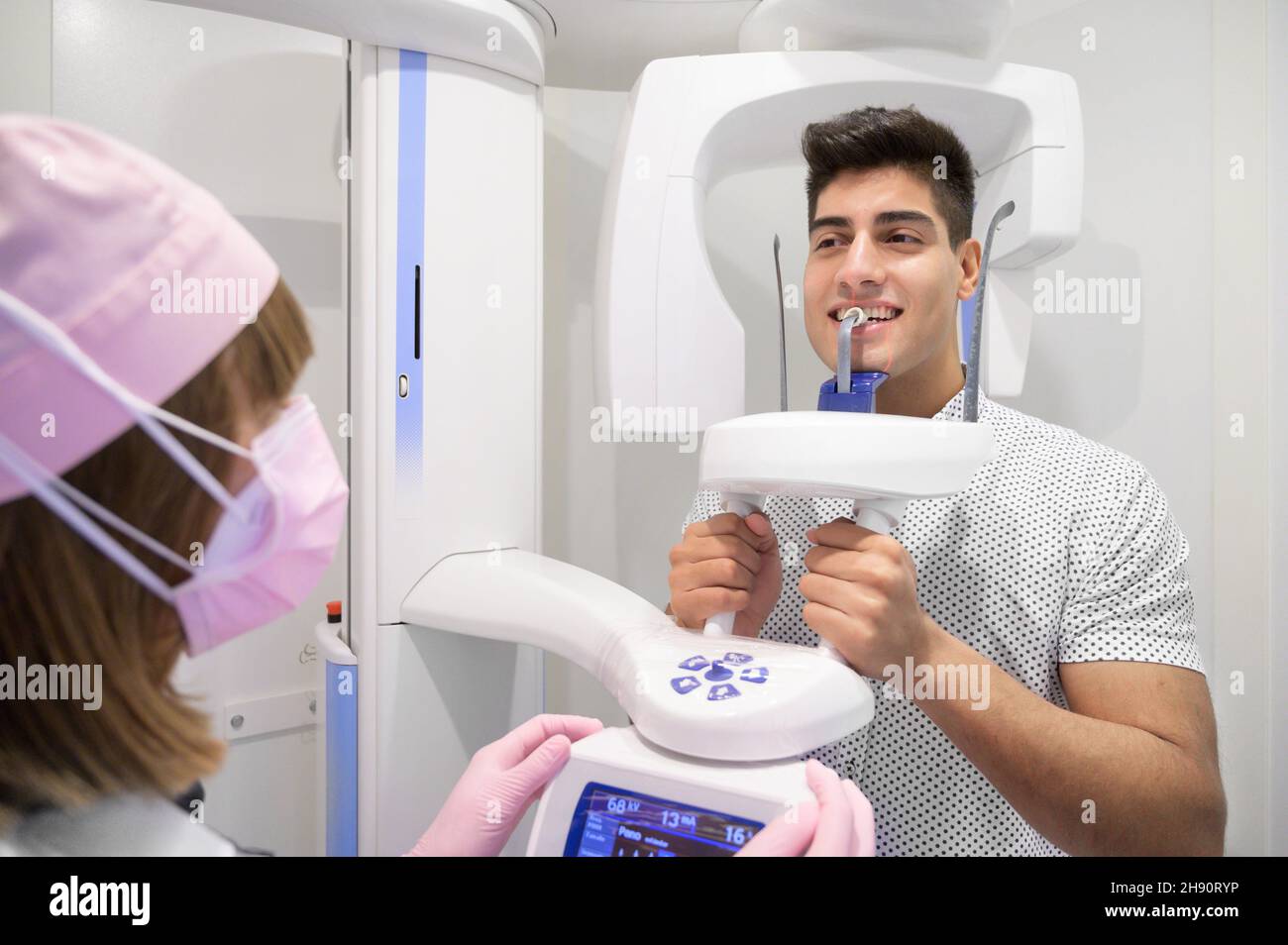 Jeune homme patient debout dans une machine à rayons X. Radiographie panoramique. Photo de haute qualité. Banque D'Images