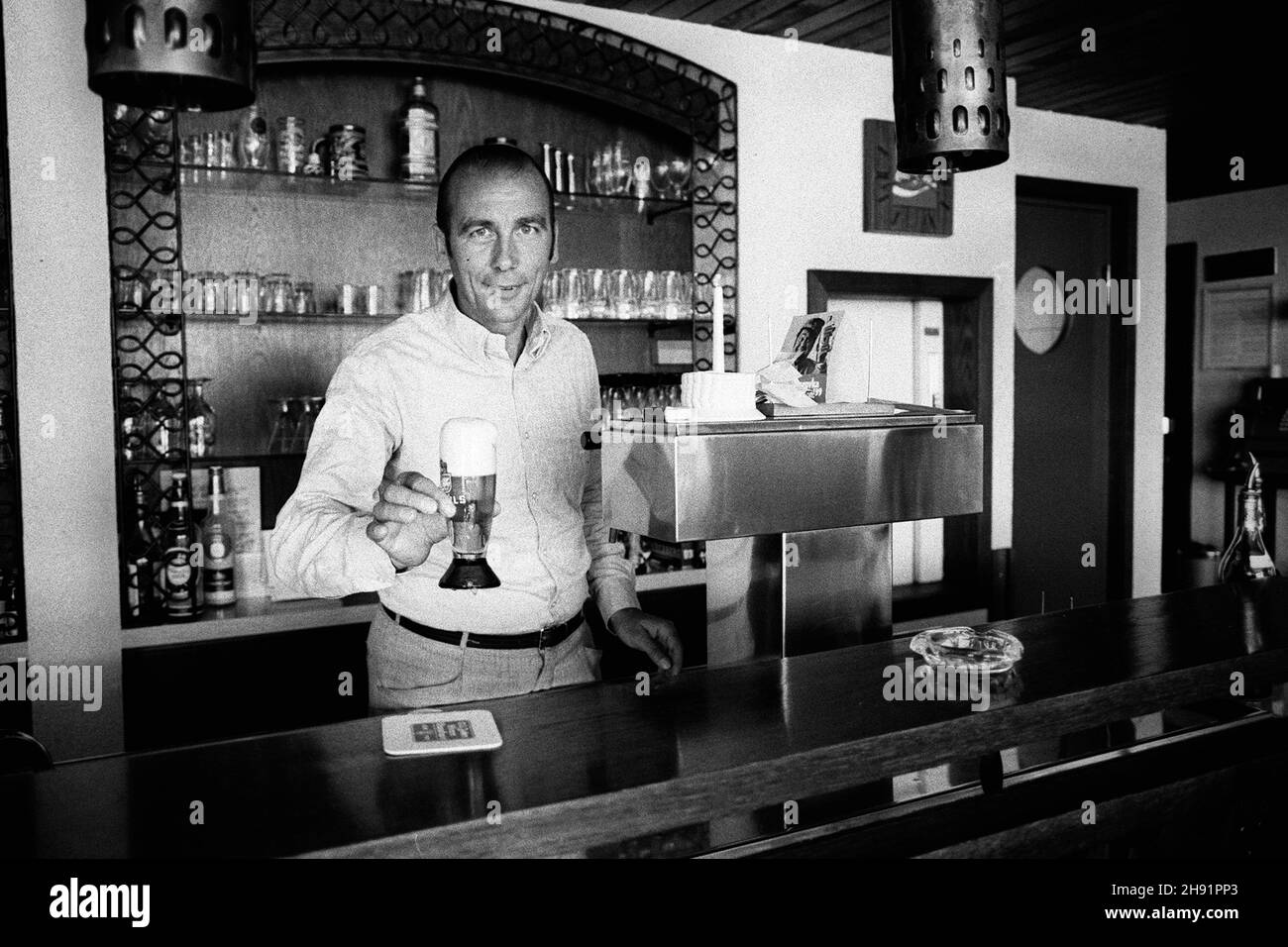 Horst Eckel est mort aujourd'hui (3 décembre 2021)!Horst ECKEL, Allemagne, ancien joueur de football, champion du monde de football de 1954, se tient derrière le comptoir dans un restaurant et prend une bière, demi-figure, 02.25.1973. Vé-ÇvÇ Banque D'Images