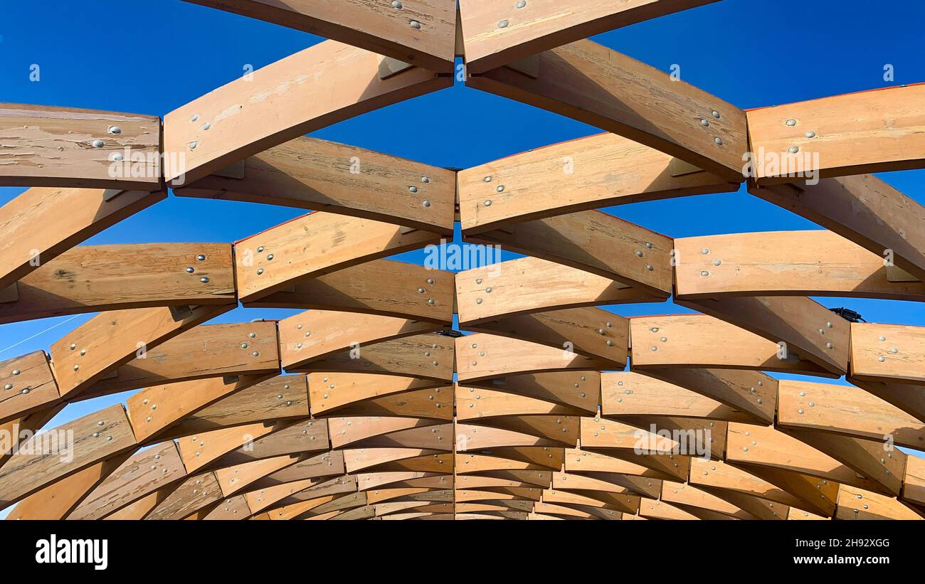 Structure architecturale en bois avec un motif géométrique sur un ciel bleu Banque D'Images
