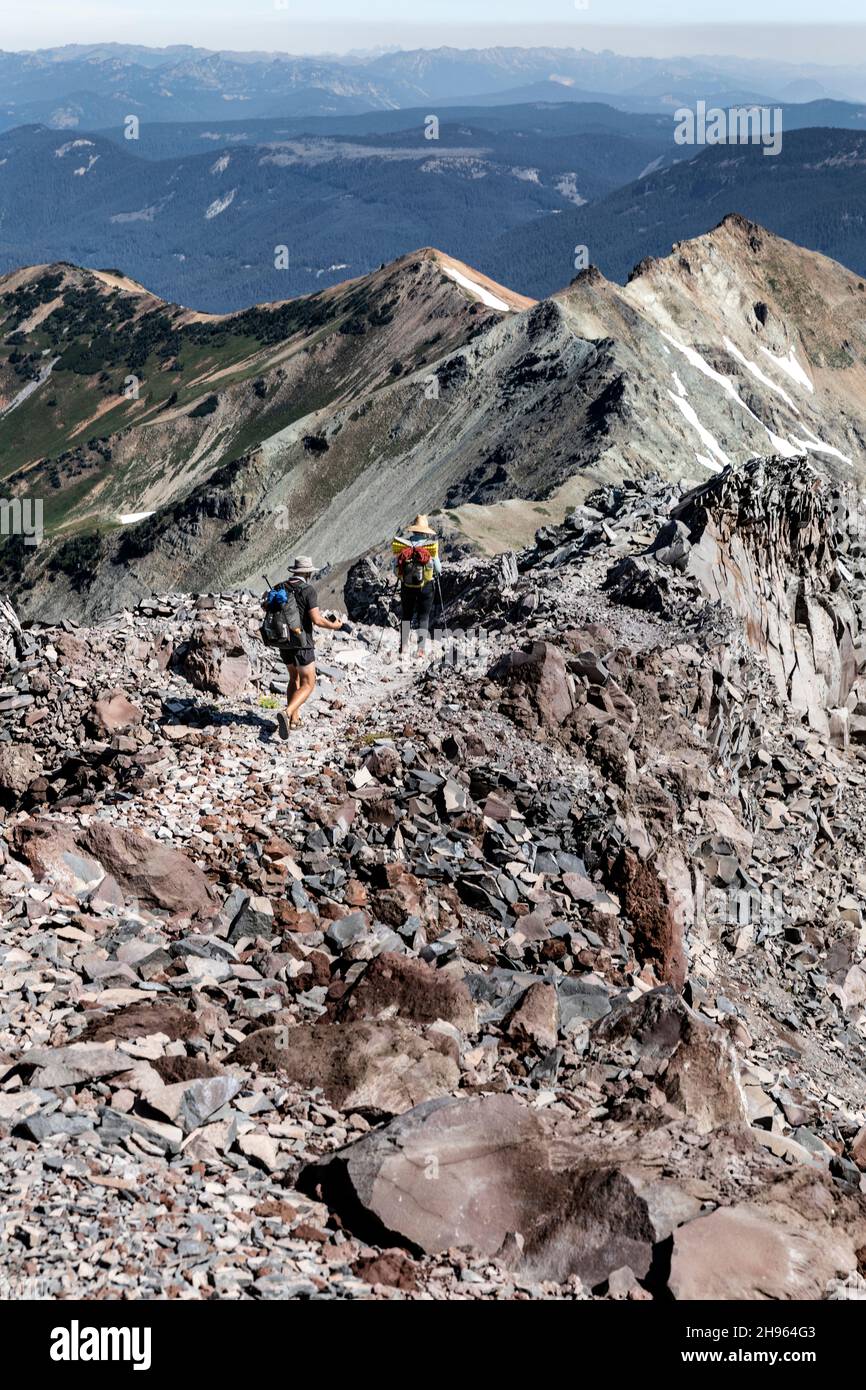 WA20484-00....WASHINGTON - randonneurs sur le Pacific Crest Trail dans la nature sauvage de Goat Rocks, dans la forêt nationale Gifford Pinchot.Mont Rainier dans la dista Banque D'Images