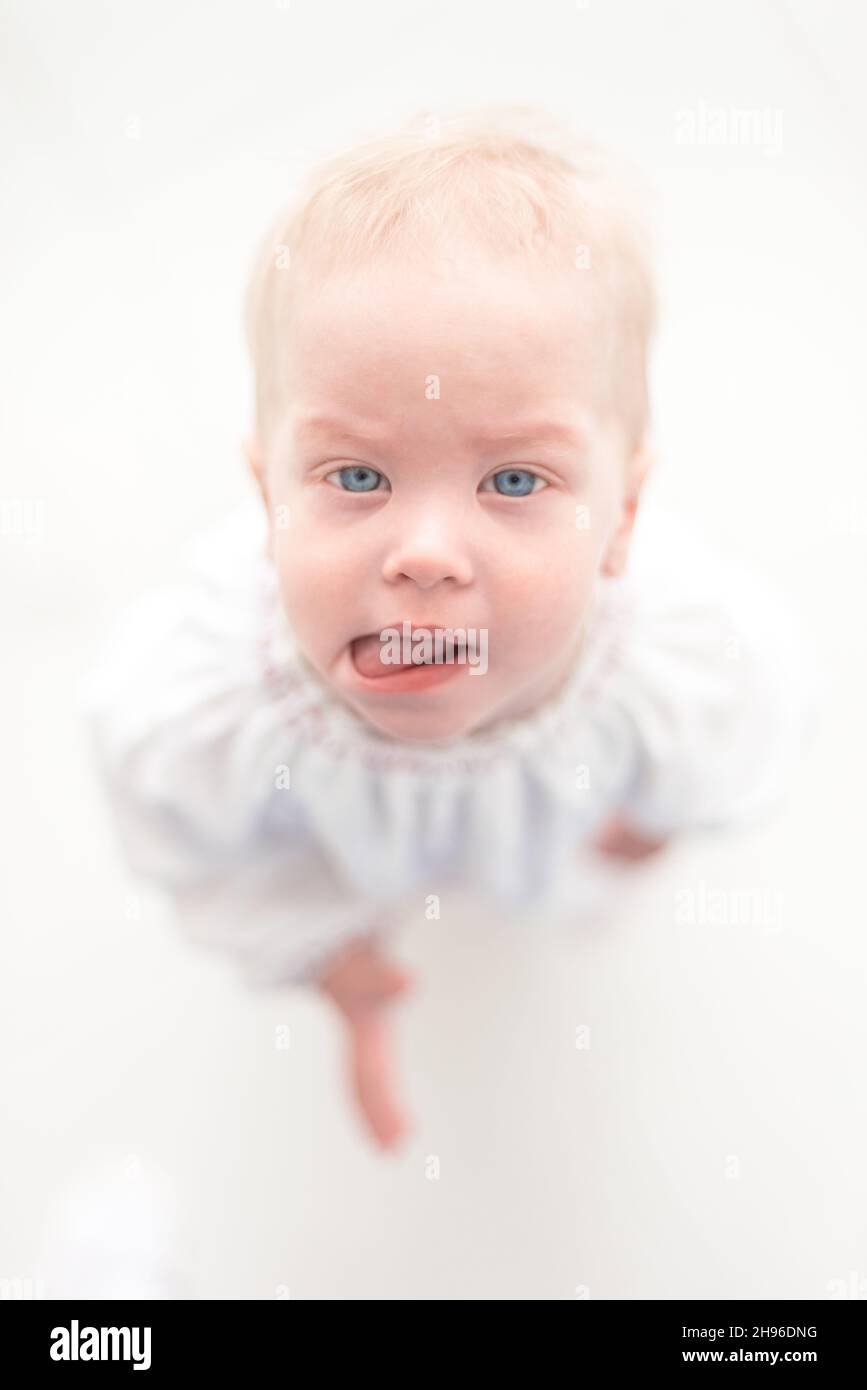 Cute baby girl toddler est montrant sa langue Banque D'Images