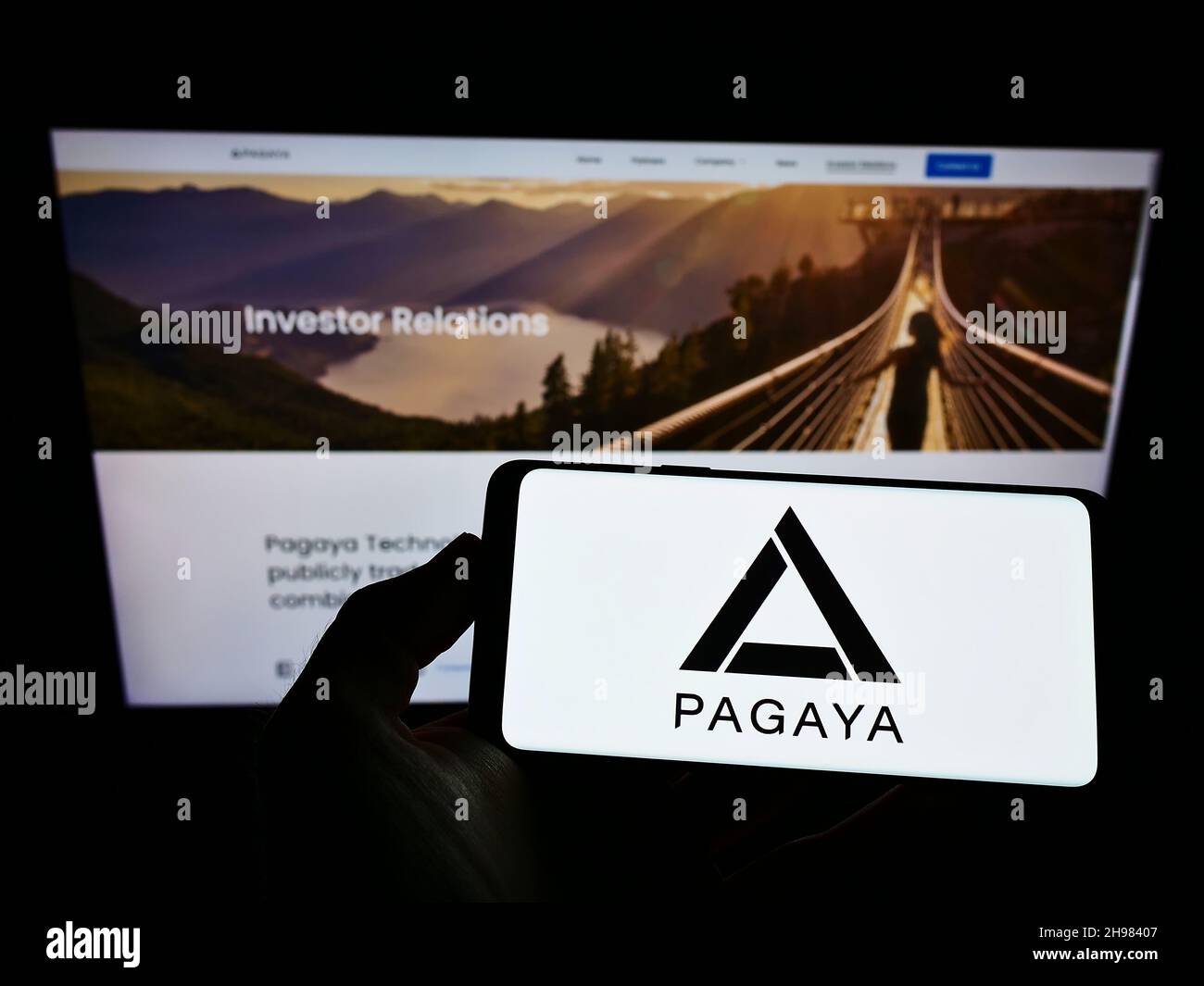 Personne tenant un smartphone avec le logo de la société de technologie financière Pagaya Investments sur l'écran devant le site Web.Mise au point sur l'affichage du téléphone. Banque D'Images
