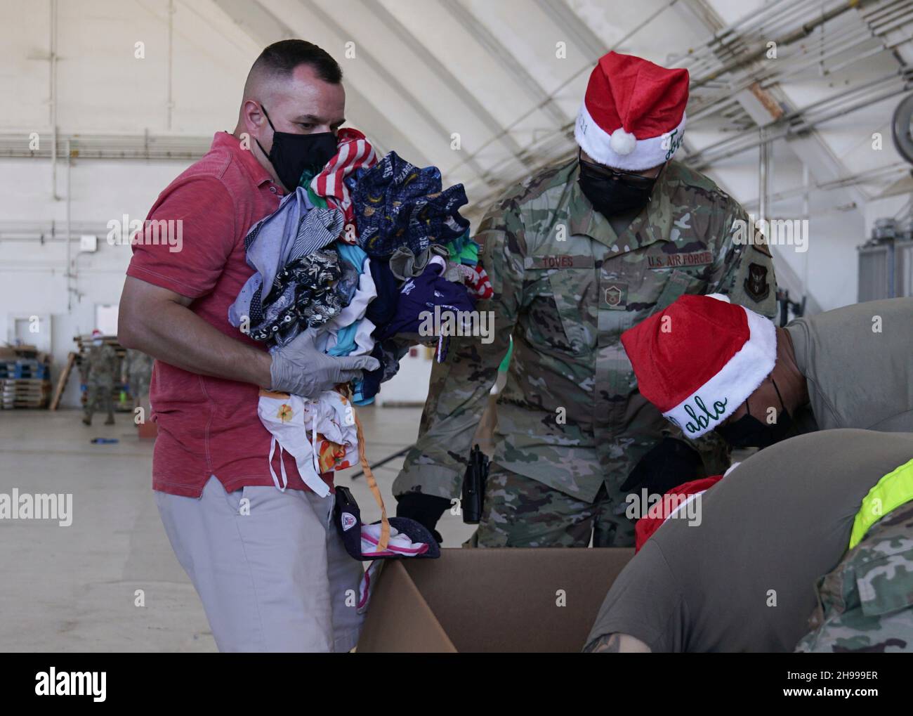 Yigo, États-Unis.04e décembre 2021.Les bénévoles emballez les produits donnés et décorent les paquets de gouttes d'air avec des messages à l'appui de la 70e chute de Noël annuelle de l'opération à la base aérienne d'Andersen le 4 décembre 2021 à Yigo, Guam.Chaque mois de décembre, des équipages feront don par avion de nourriture, de fournitures, de matériel éducatif et d’outils à 55 nations insulaires du Pacifique Sud-est.Crédit : MSGT.Richard Ebensberger/US Airforce photo/Alamy Live News Banque D'Images