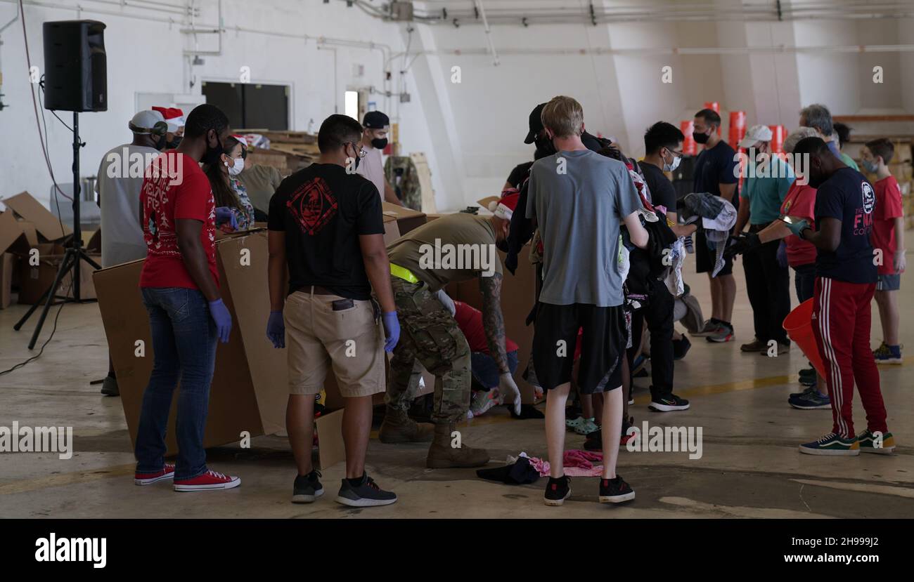 Yigo, États-Unis.04e décembre 2021.Les volontaires emballez les produits donnés dans des paquets de gouttes d'air lors des préparatifs de la 70e chute de Noël annuelle de l'opération à la base aérienne d'Andersen le 4 décembre 2021 à Yigo, Guam.Chaque mois de décembre, des équipages feront don par avion de nourriture, de fournitures, de matériel éducatif et d’outils à 55 nations insulaires du Pacifique Sud-est.Crédit : MSGT.Richard Ebensberger/US Airforce photo/Alamy Live News Banque D'Images