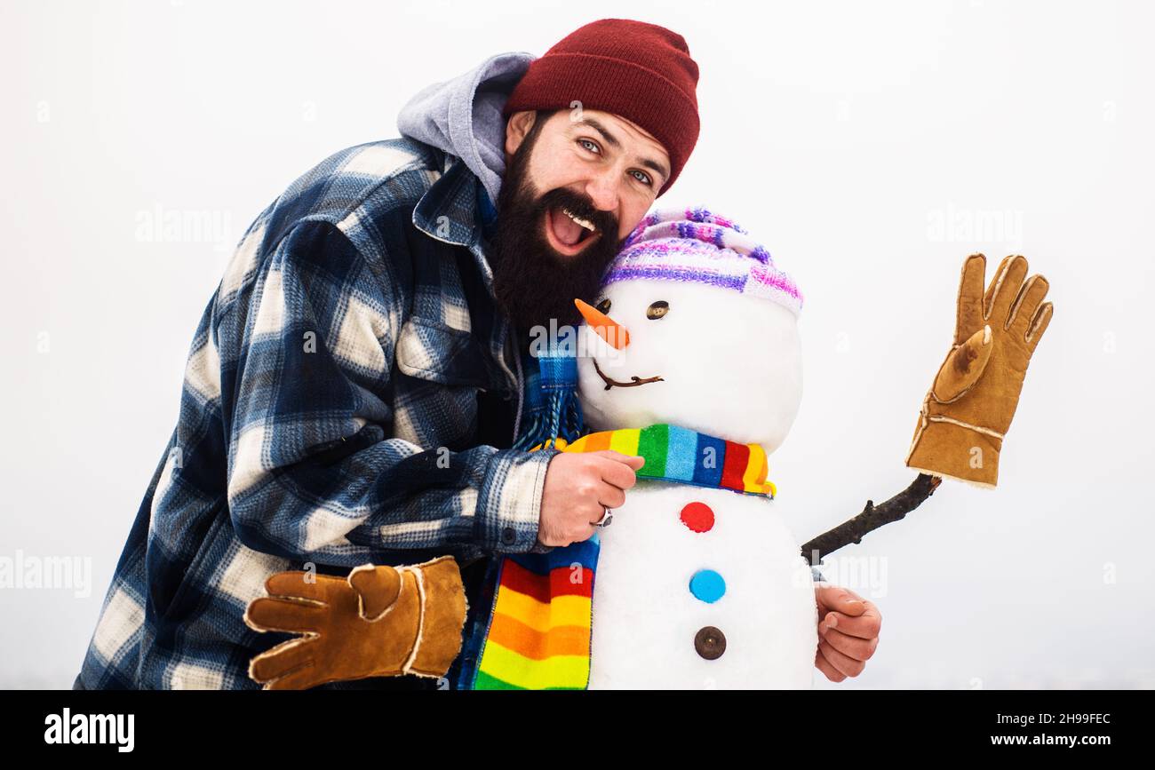 Homme barbu avec bonhomme de neige de Noël.Loisirs en hiver.Bonne heure d'hiver.Homme jouant avec Snowmen Banque D'Images
