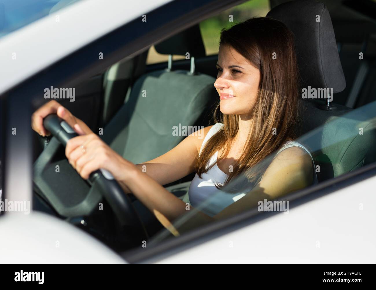 Vue latérale du young woman driving car Banque D'Images