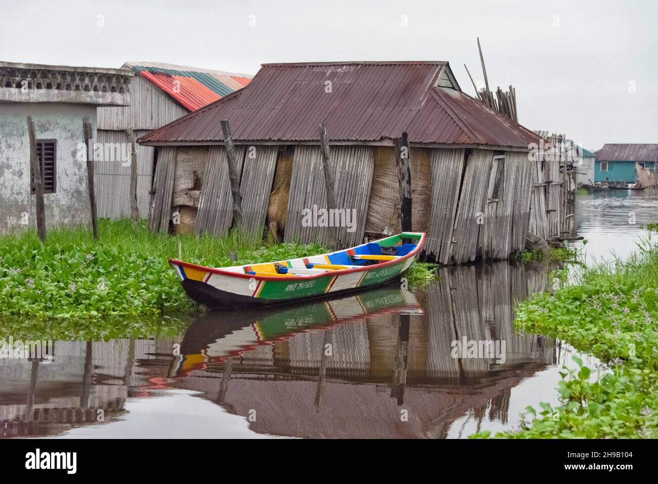 Bateau coloré et le village lacustre de Ganvie sur le lac Nokoue, Bénin Banque D'Images
