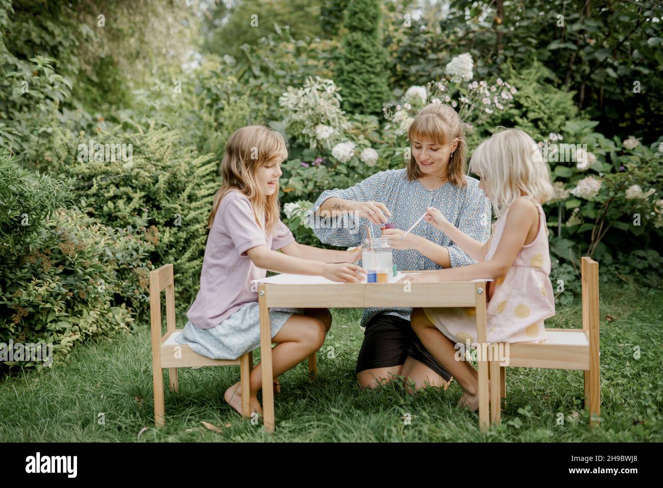 Mère peint avec ses enfants dans le jardin Banque D'Images
