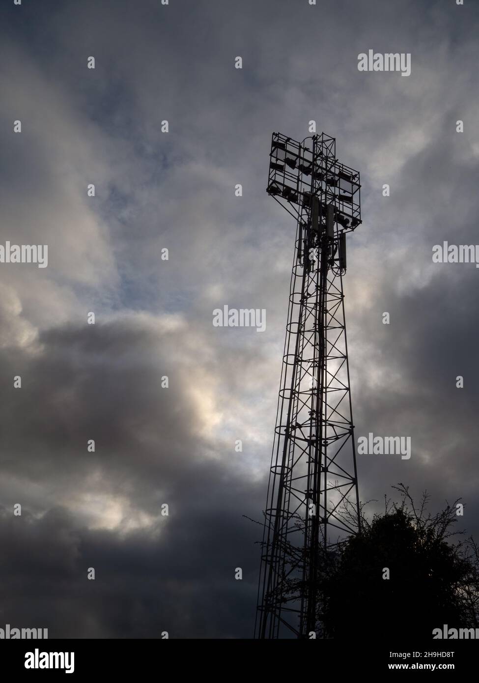 Les projecteurs de stade et le ciel orageux. Banque D'Images