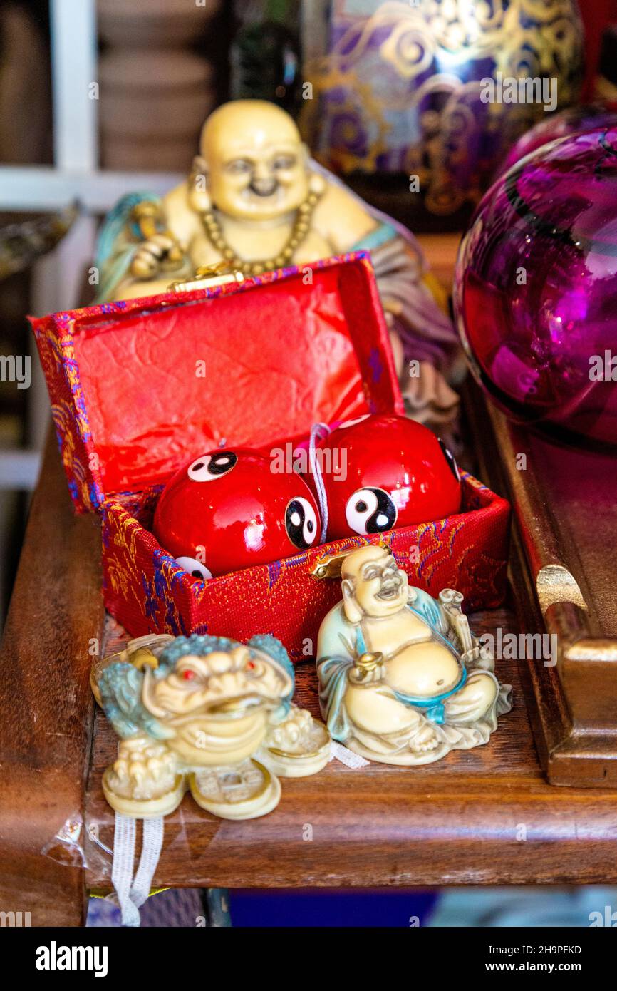 Ballons de stress chinois et figurines de bouddha dans un magasin d'antiquités (Hampton court Emporium, East Molesey, Royaume-Uni) Banque D'Images