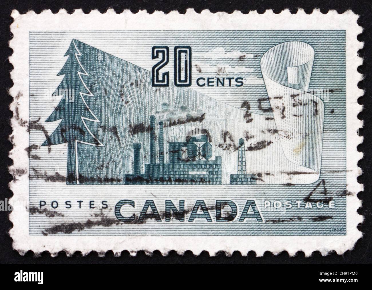 CANADA - VERS 1952 : un timbre imprimé au Canada montre des symboles de la production de papier journal, de l'arbre au papier, vers 1952 Banque D'Images