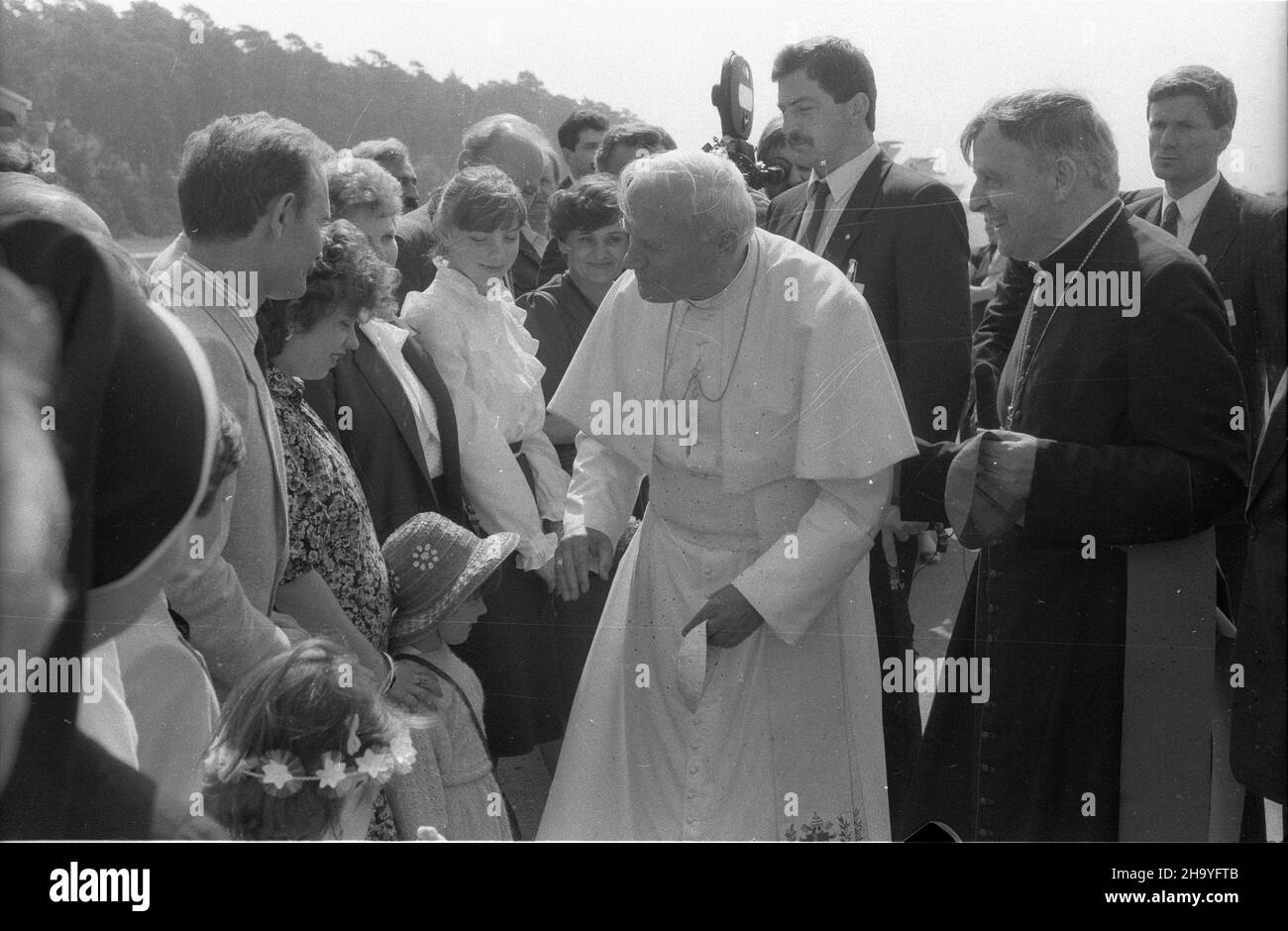 Szczecin, 1987-06-11.III pielgrzymka Ojca Œwiêtego Jana Paw³a II do Polski.¿a na lotnisku W Goleniowie.NZ. m.in.: papie¿ Jan Pawe³ II (4P) i arcybiskup Kazimierz Majdañski (2P).W tle za Ojcem Œwiêtym stoi oficer Biura Ochrony Rz¹du (BOR) - Miros³aw Gawor (3P). ppr PAP/CAF/Jerzy UNDROSzczecin, 11 juin 1987.Le 3ème pèlerinage du Saint-Père Jean-Paul II en Pologne.La cérémonie d'accueil à l'aéroport de Goleniow.Photo : le pape Jean-Paul II (4e de droite), l'archevêque Kazimierz Majdanski (2e de droite).En arrière-plan derrière le Saint-Père Miroslaw Gawor, le Banque D'Images