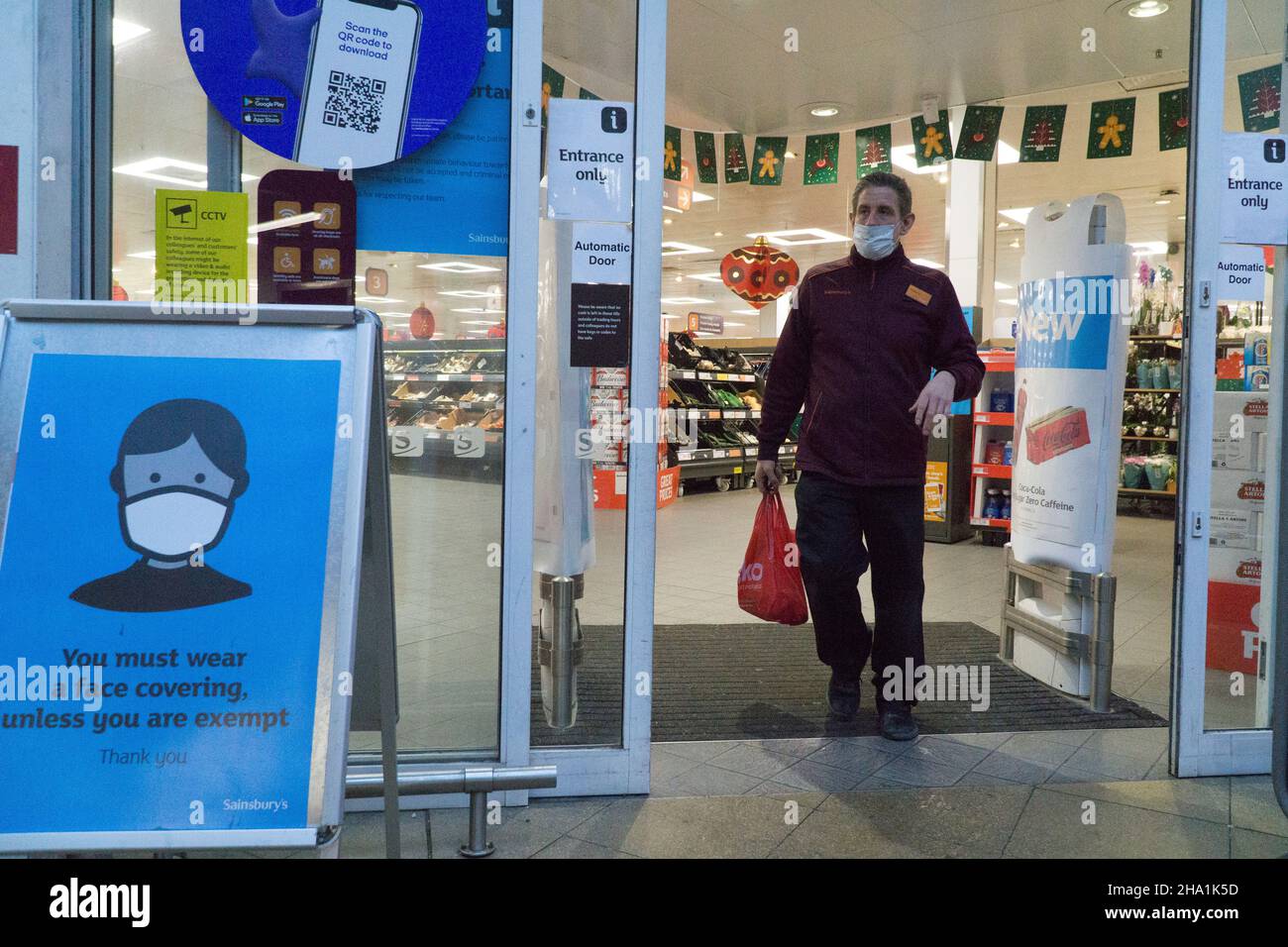 Londres, Royaume-Uni, 6 décembre 2021: Les masques sont désormais obligatoires dans les magasins, sauf si les clients sont médicalement exemptés, dans l'espoir qu'ils pourraient freiner la propagation de la variante Omicron du coronavirus, qui est censé être déjà en transmission communautaire.À cette succursale de Sainsbury's, un panneau de signalisation à l'entrée demande aux clients de coopérer pour assurer la sécurité des autres.Anna Watson/Alay Live News Banque D'Images