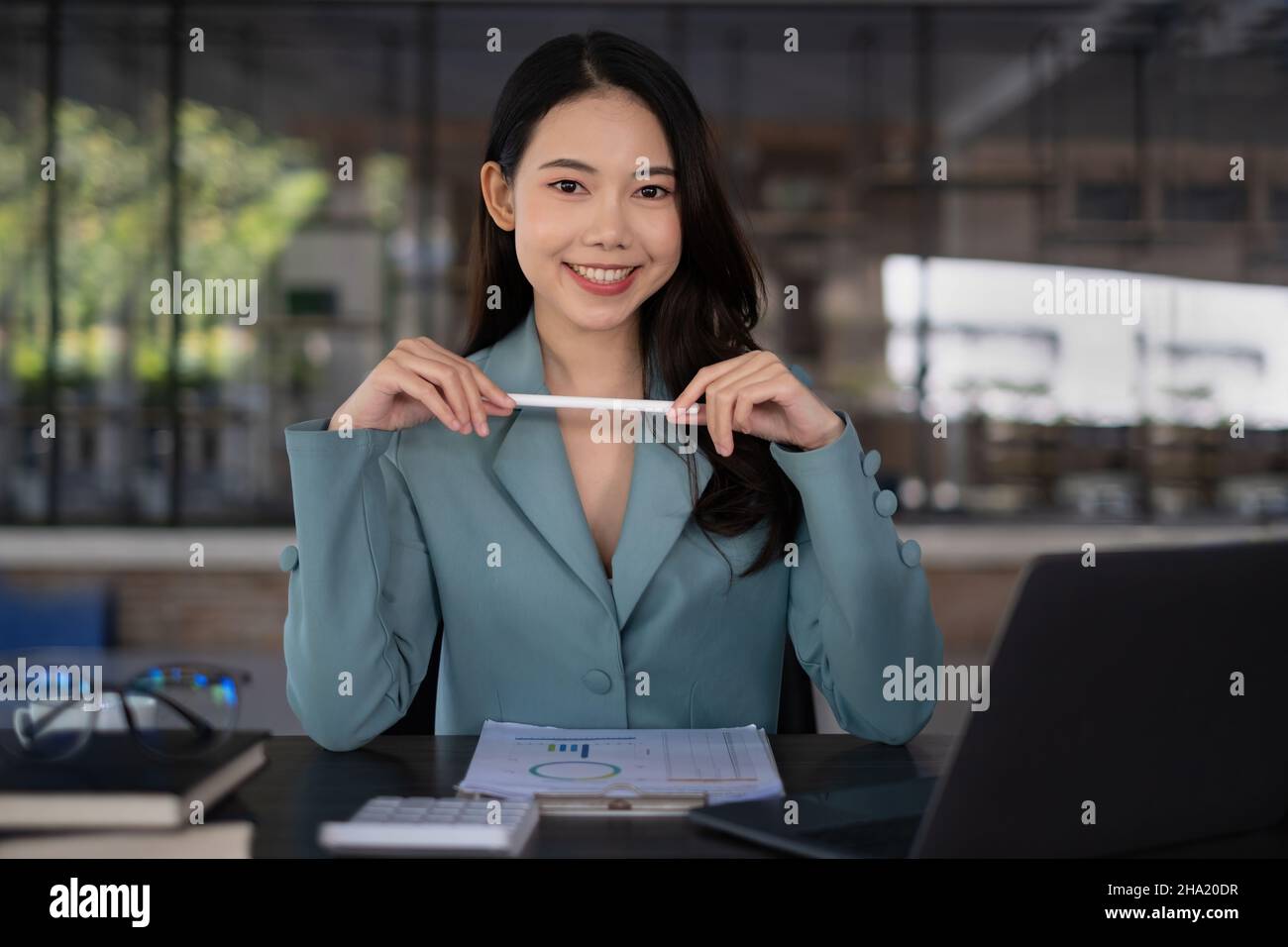 Une femme d'affaires asiatique excitée et célébrant le succès et la vidéoconférence avec son équipe d'affaires.Finance, impôts, fonds, concept de compte Banque D'Images