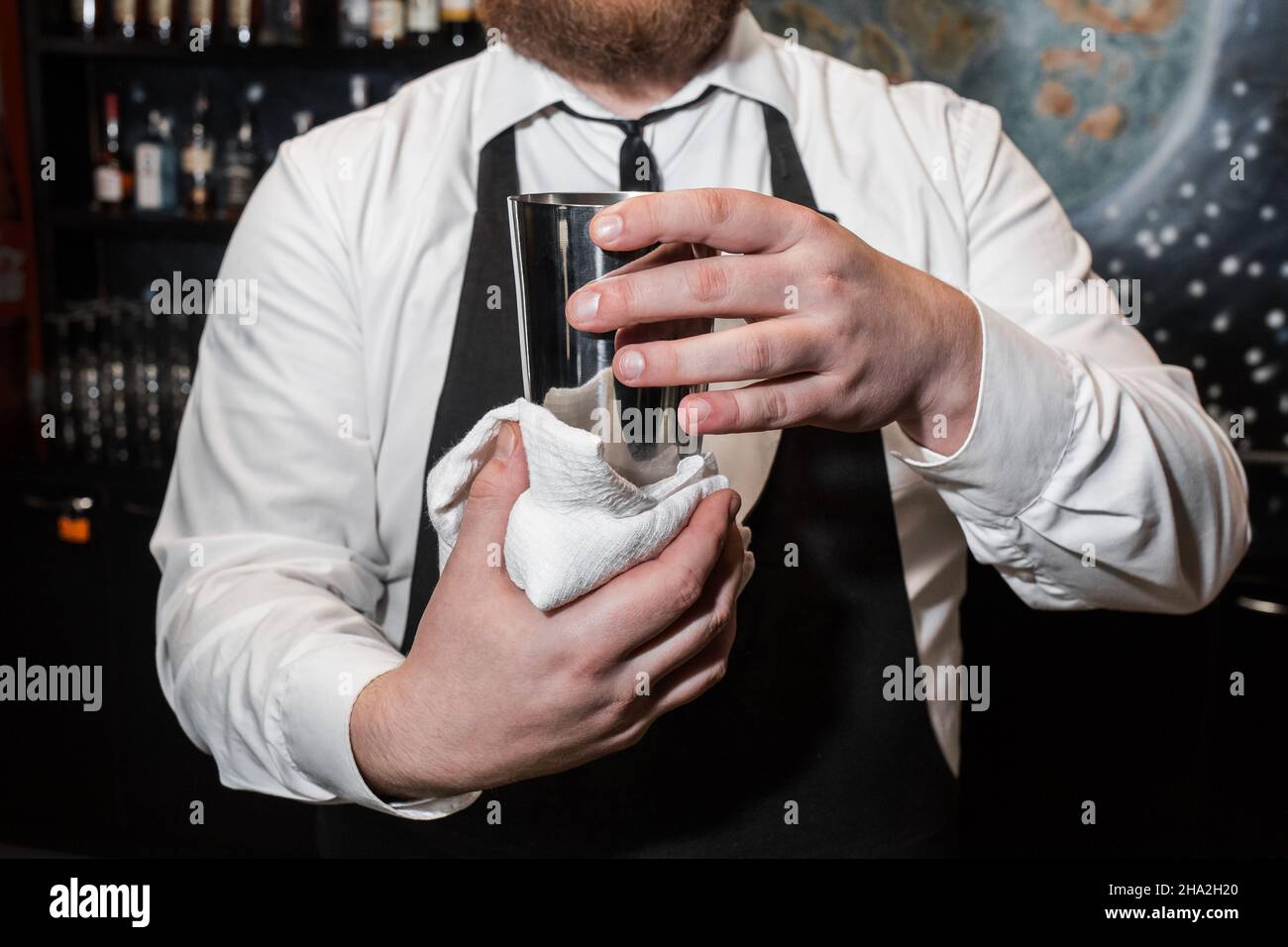 https://c8.alamy.com/compfr/2ha2h20/un-barman-professionnel-tient-un-agitateur-metallique-pour-melanger-et-preparer-des-cocktails-alcoolises-et-l-essuie-avec-un-chiffon-blanc-2ha2h20.jpg
