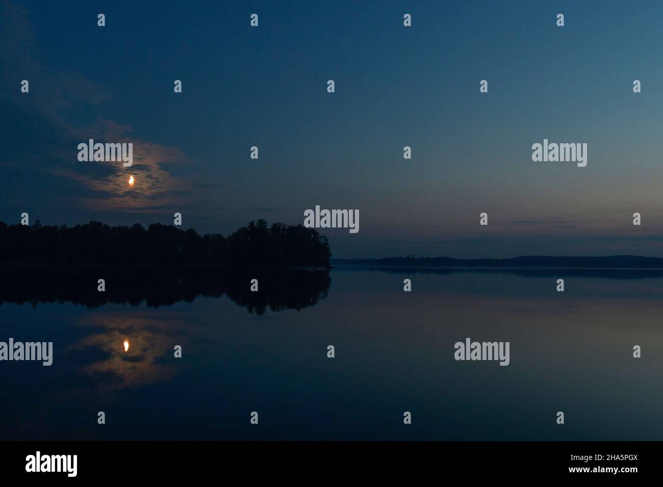 lune se lève au-dessus du calme lac de bolmen,småland,suède Banque D'Images