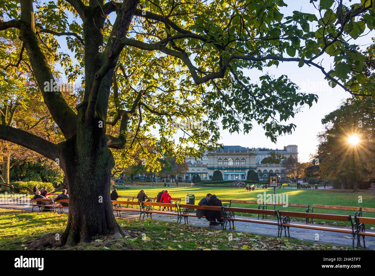vienne, parc stadtpark, les gens aux bancs bénéficient du dernier soleil de la journée, couleurs d'automne, vue au kursalon hübner en 01. vieille ville, vienne, autriche Banque D'Images
