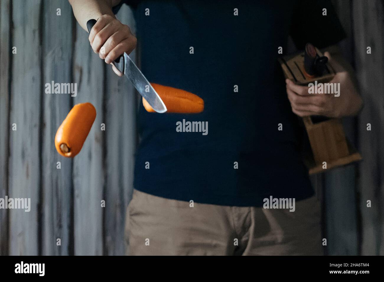 homme coupant la carotte en deux comme un ninja de fruit Banque D'Images
