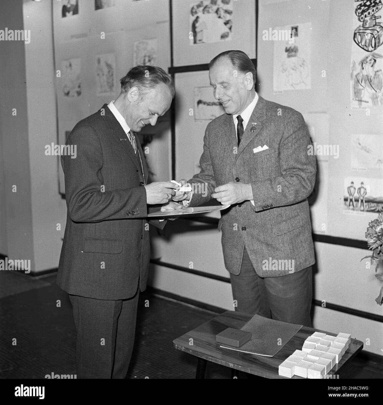 Varsovie, 1969-12-02.Eryk Lipiñski, redaktor naczelny Szpilek wrêczy³ nagrotty tygodnika dla polskich uczestników miêdzynarodowej wystawy W Moskwie pt.Satyra W walce o pokój.I nagrodê otrzyma³ karykaturzysta Trybuny Ludu Stefan Wielgus za pracê pt.Cicha œmieræ.NZ.Eryk Lipiñski (P) i Stefan Wielgus (L). mb PAP/Adam UrbanekVarsovie, le 2 décembre 1969.Le rédacteur en chef du mensuel Szpilki Eryk Lipinski a remis des prix aux participants polonais de l'exposition internationale de Moscou sur la satire aidant les gens à lutter pour la paix.Le caricaturiste du quotidien Trybuna Ludu Stefan Wielgus a reçu le prix 1st pour Banque D'Images