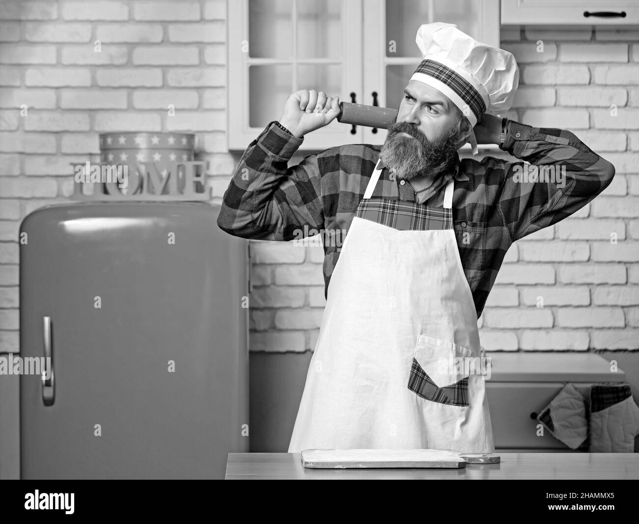 Portrait du chef cuisinier en uniforme à la cuisine maison. Banque D'Images