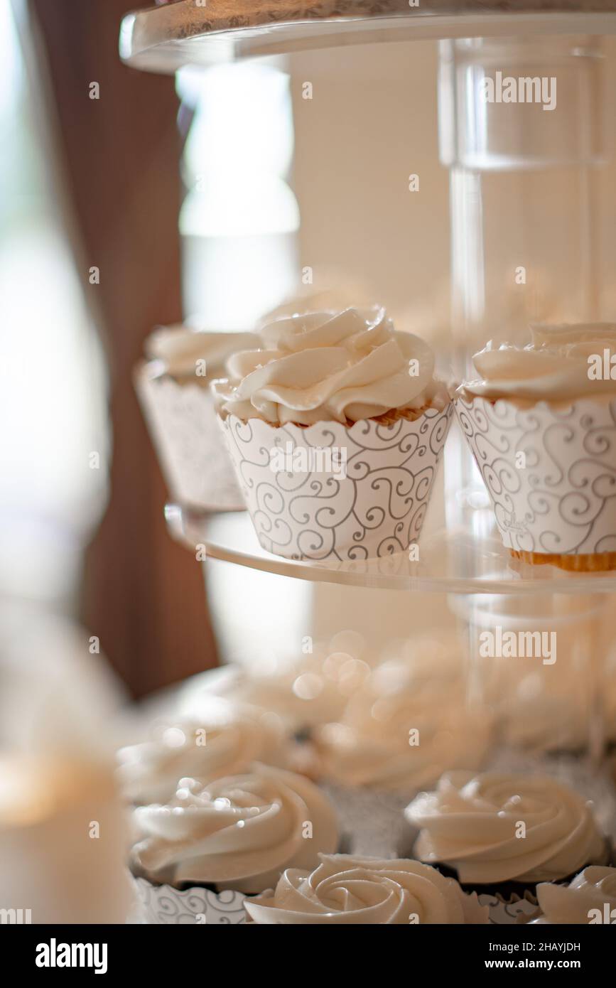 cupcakes vanille dans des tasses en dentelle blanche sur la tour à gâteau Banque D'Images