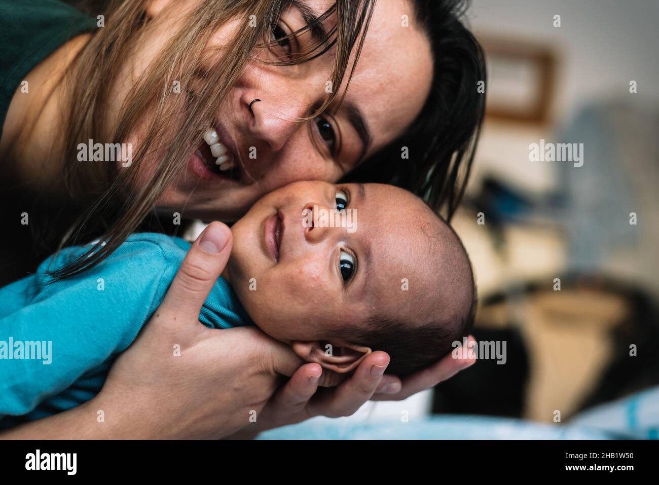 Portrait d'une jeune femme souriant avec son bébé. Banque D'Images