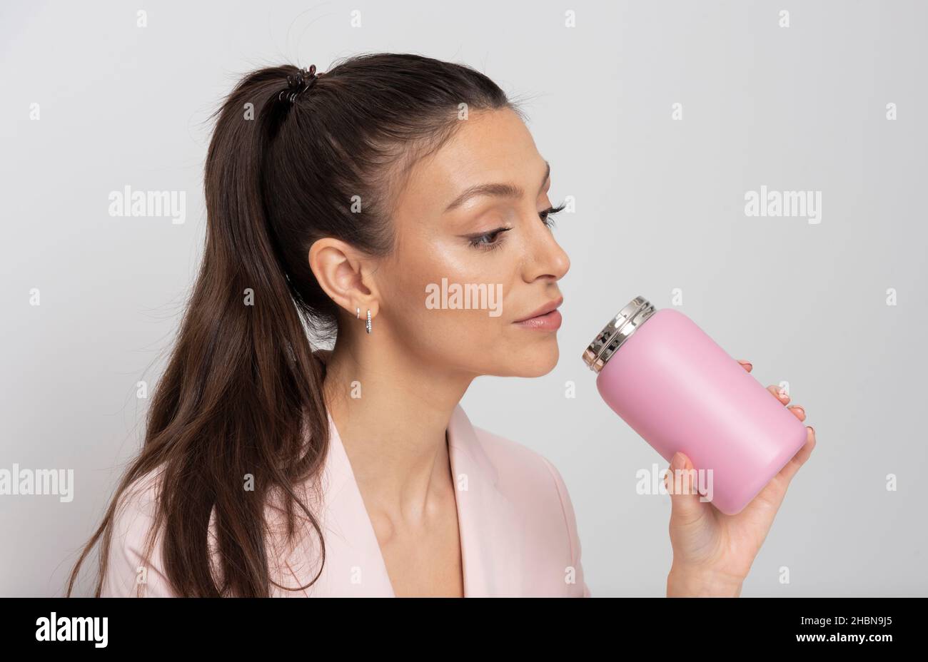 Salisbury, Royaume-Uni.2021. Une employée de bureau boit dans une fiole rose Banque D'Images