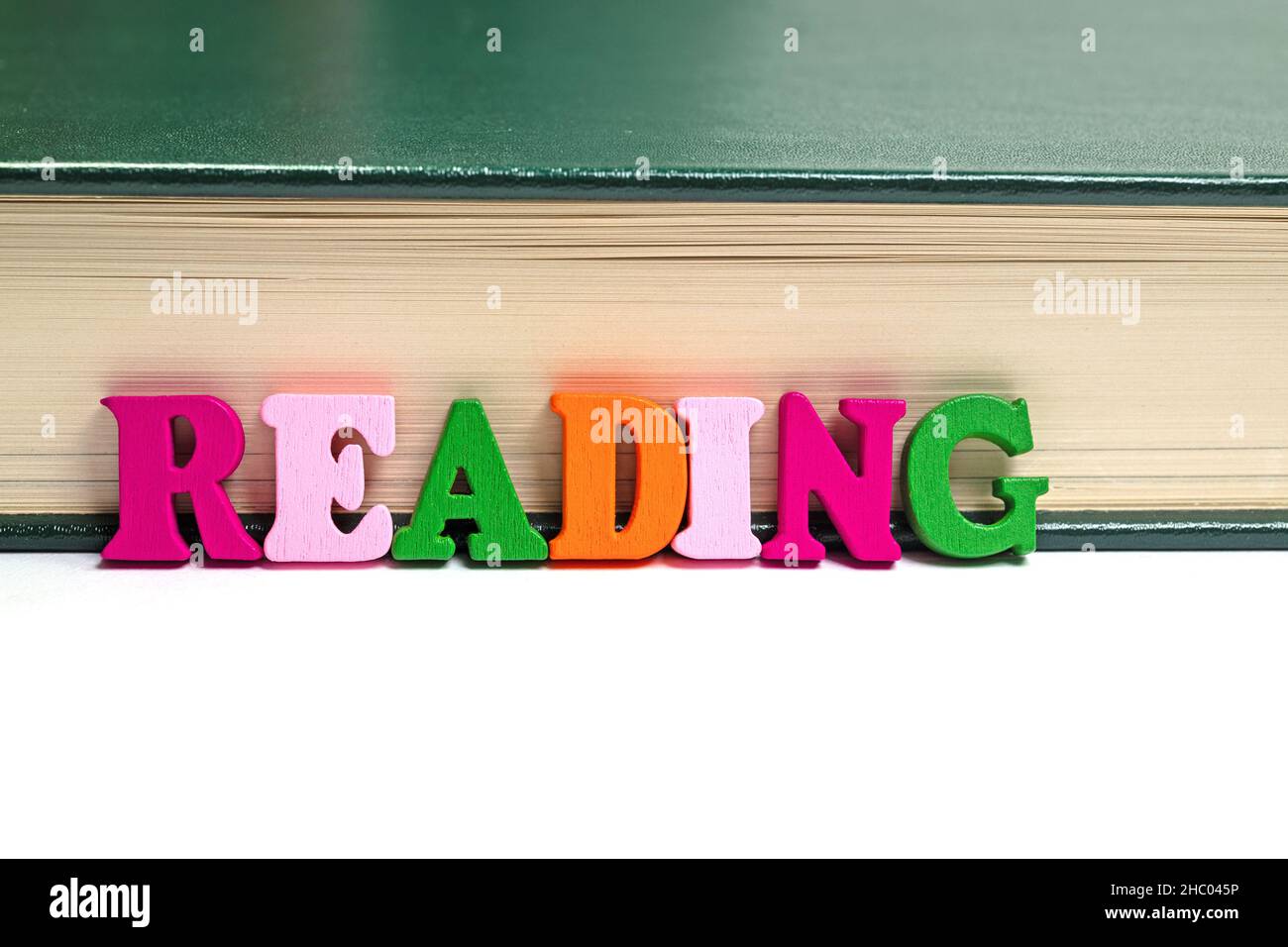 Lettres colorées devant un livre Banque D'Images