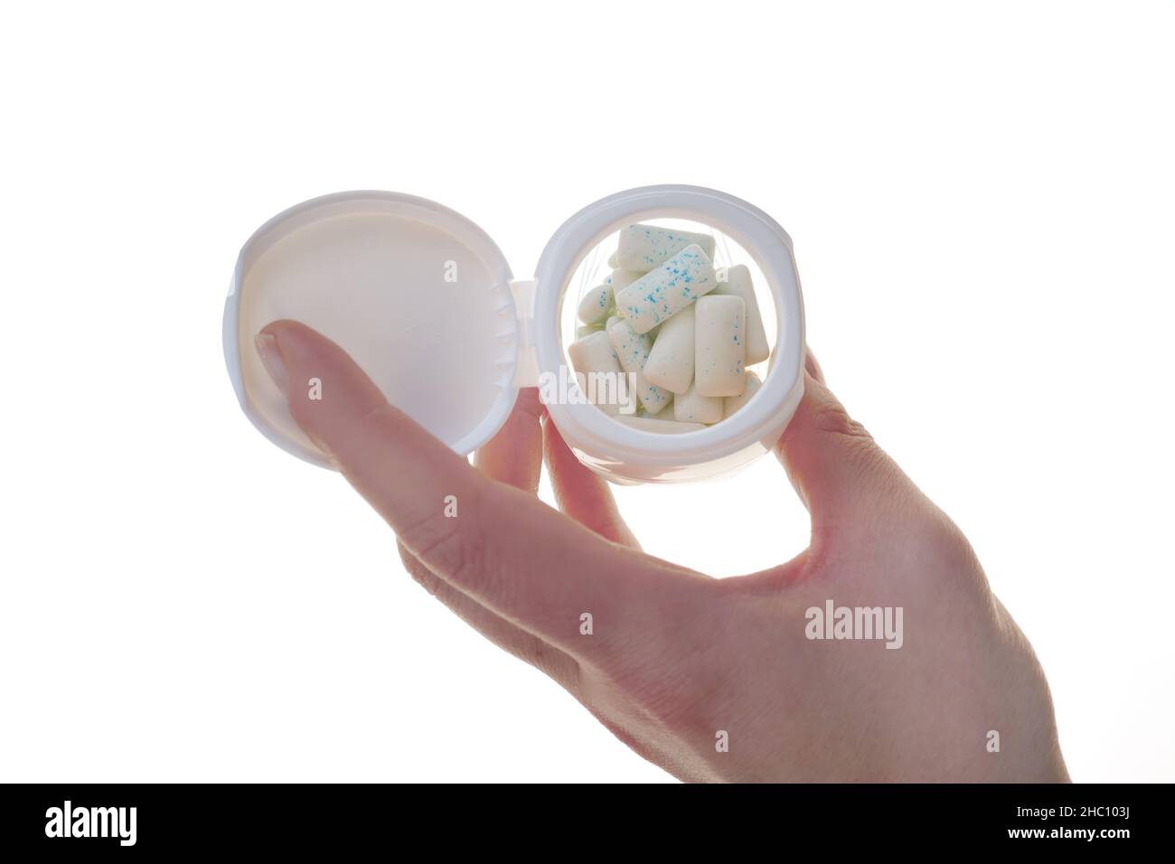 Tampons de gomme à bulles dans un pot à la main isolé sur un fond blanc.Santé dentaire et buccale.Chewing-gum à la menthe . Banque D'Images