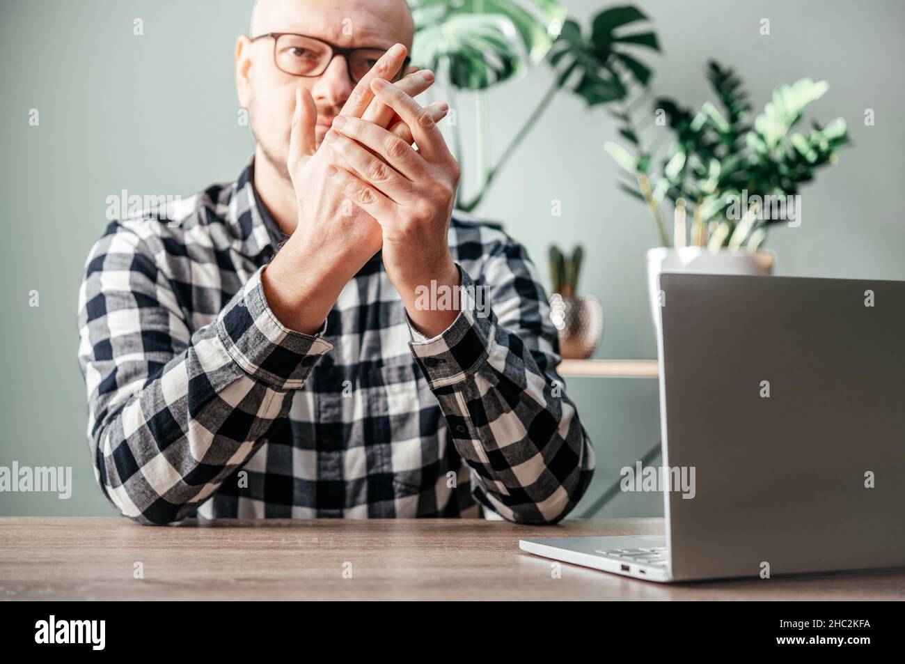 Un homme sentant la douleur dans sa main, la polyarthrite rhumatoïde et les articulations inflammation concept Banque D'Images