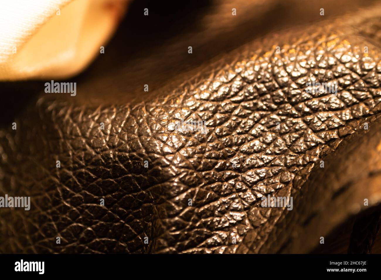 Détail cuir brun foncé avec éclairage chaleureux Banque D'Images