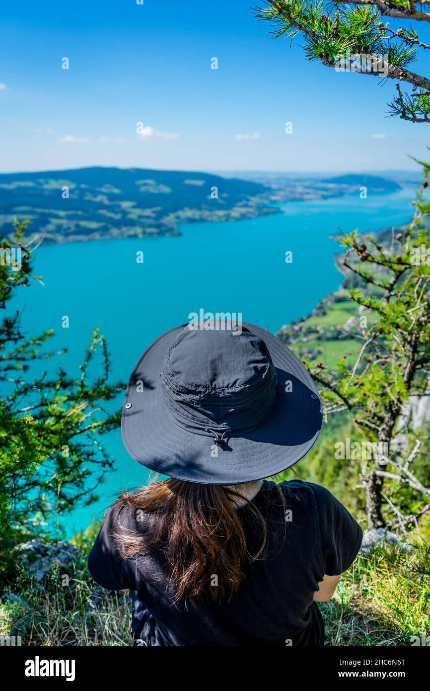 Randonneur féminin se reposant au mont Schoberstein et regardant vers le lac Atter (Attersee) dans les alpes, Autriche Banque D'Images