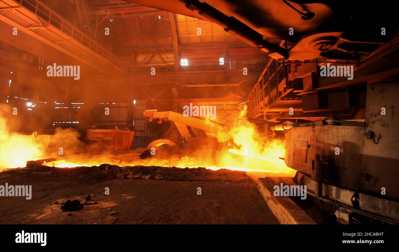 L'acier chaud est versé à la goulotte de l'usine d'acier, concept de l'industrie lourde.Production d'acier fondu dans les fours électriques. Banque D'Images