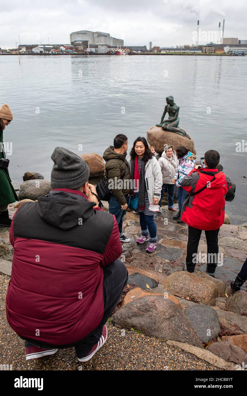 Les touristes ayant leur photo prise par la petite statue de Sirène ou sculpture sur un décembre gris à Copenhague, Danemark Banque D'Images
