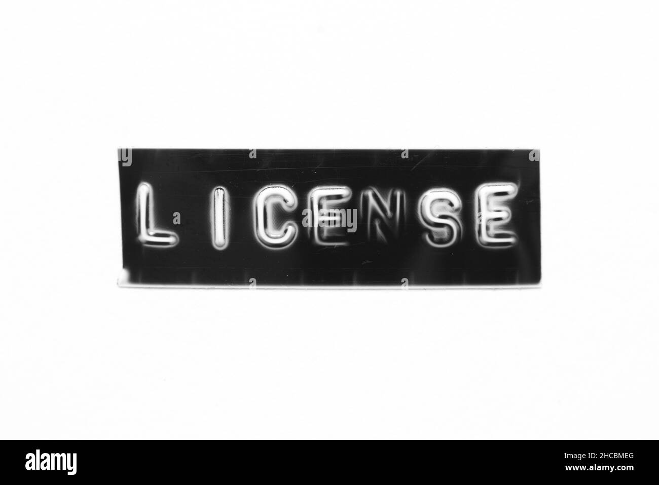 Bannière noire avec lettre en relief et licence de mot sur fond de papier blanc Banque D'Images
